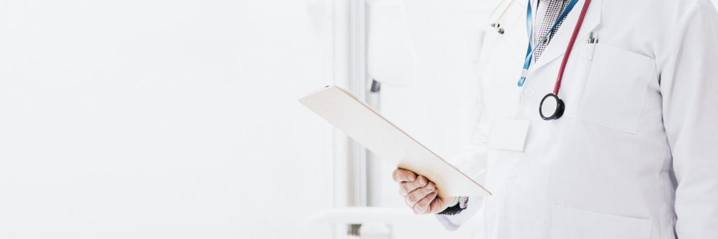 Doctor reading a coronavirus patient medical chart dr