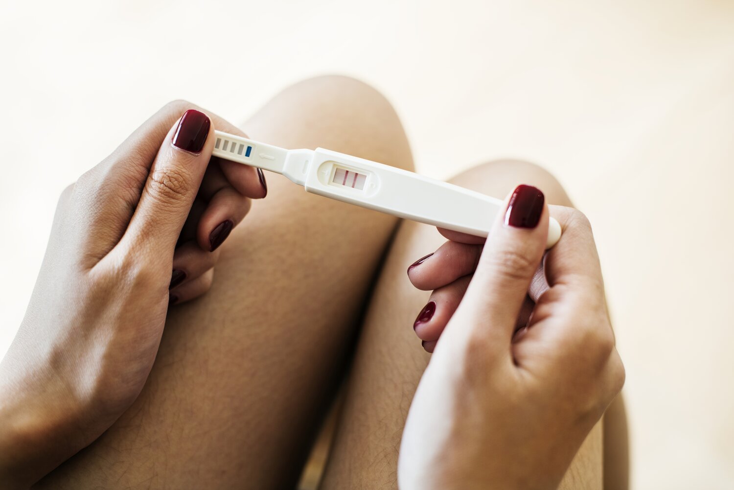 Woman holding a positive pregnancy test pregnancytest